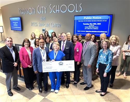 nurse becky tucker surrounded by colleagues in Central Office lobby